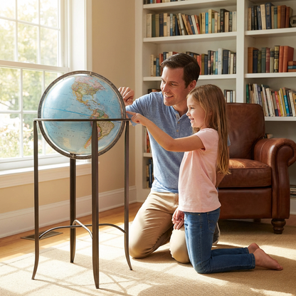A father and daughter look at the Replogle Globes Trafalgar Blue Ocean Floor Globe in a sunlit living room, with the man pointing to a location on the map .