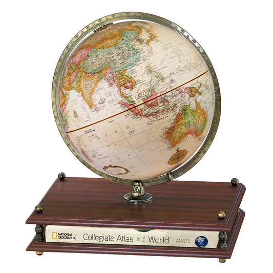 Replogle Premier 12-inch antique desktop globe on a dark wood base with a National Geographic atlas.