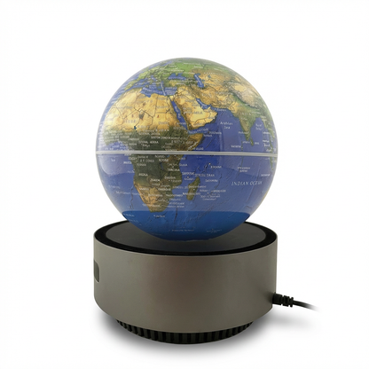 A studio photograph shows the Replogle Self Floating Levitating 6" Blue Ocean Desk Globe angled to the right on a pure white background. The globe hovers above its grey circular base, which has a soft shadow beneath it. The map shows Africa, the Middle East, and the Indian Ocean.